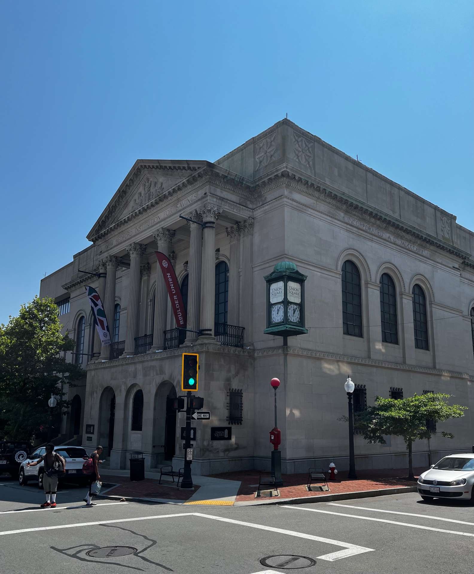 Boulder Union at the historic New Bedford Institution for Savings building, 174 Union Street, New Bedford — limestone columns, arched windows, and the corner clock at Union Square
